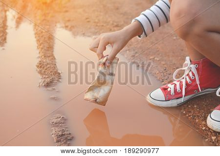Hand girl holding box garbage to save environment selective and soft focus