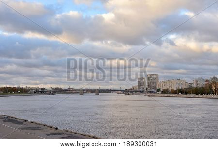 View of Neva river and Volodarsky Bridge at cloud autumn day in St.Petersburg Russia.