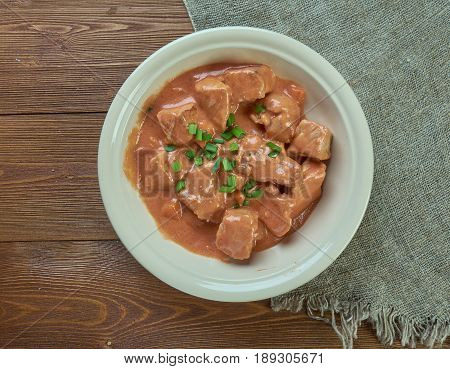 Schweinegulasch - German goulash in sauce. close up