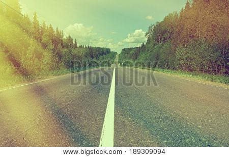 sunset, road in Russian forest. Arhangelsk region