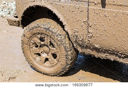 Dirty wheel of an off-road car after driving in the rain