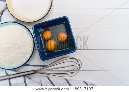 Ingredients for baking a cookies. Recipe for coconut macaroons. Top view with copy space.