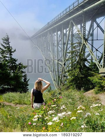 Happy women hiking by ocean in foggy morning. Deception Pass Bridge Park. Seattle. Anacortes. Washington. United States.