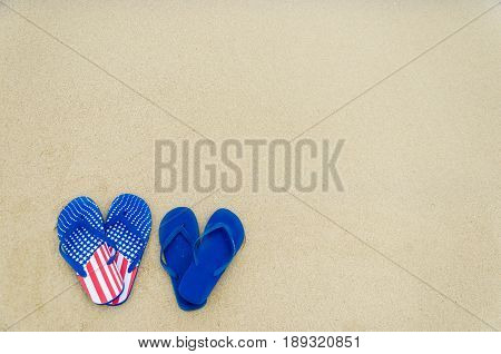 Patriotic USA background with flip flops on the sandy beach
