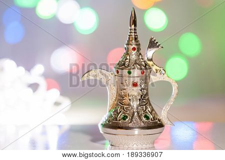 Silver Arabic Coffee pot  in colorful background. Ramadan, Eid concept