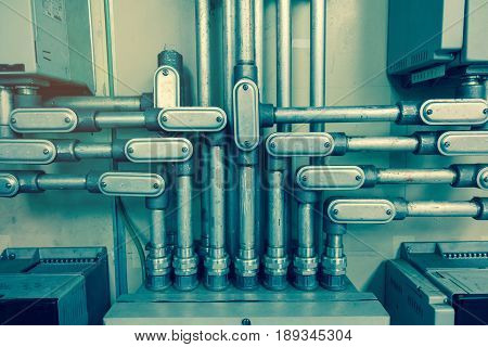 Electrical Conduit connected to junction box for connect electrical cable in box with vintage tone for industrial technology concept.
