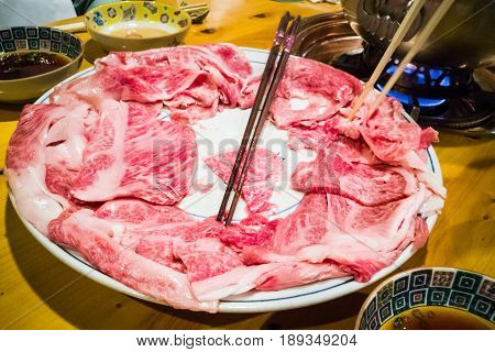 People Dining With Raw Japanese Kobe Beef Shabu-shabu Steamboat