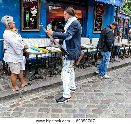 PARIS, FRANCE-JULY, 2016: Montmartre Street Painters, colorful and famous Place du Tertre