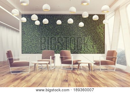Front view of an office cafe interior with a large grass wall panoramic windows with triangular frames white round tables and soft brown chairs near them. 3d rendering mock up toned image