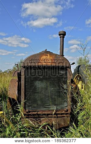 BARNSEVILLE, MINNESOTA, Sept 14,2014:The old rusty tractor grill bears the McCormick Deering logo which became a trademark name of a line of tractors and farm machinery manufactured by the International Harvester Co.