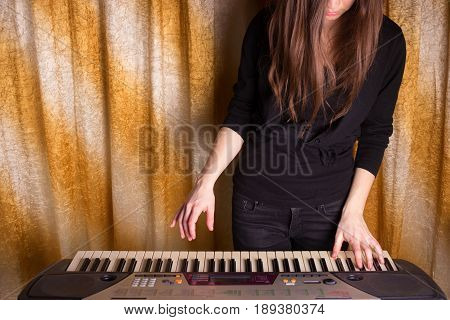 Unrecognizible Girl Musician Playing On Electronic Piano