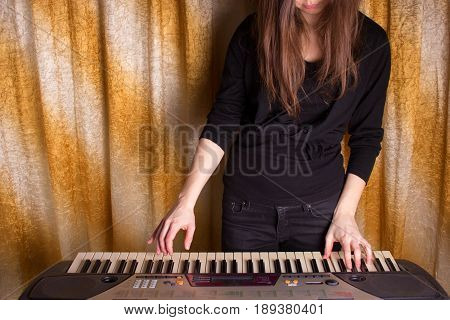 Unrecognizible Girl Musician Playing On Electronic Piano