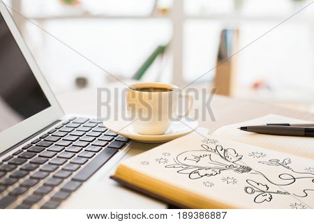 Close up and side view of office desk with laptop coffee cup and sketch in notepad. Idea concept