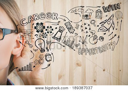 Young woman listening attentively on ooden background with business sketch. Opportunity concept