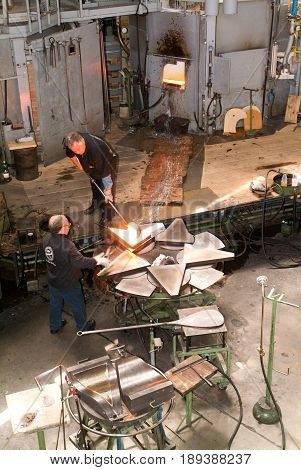 Hergiswil Switzerland - 26 april 2008: Workers during the Glass processing hot melting glasses at the industry of Glasi Hergiswil in Switzerland