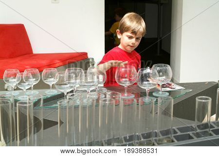 Child Making Music With Glasses