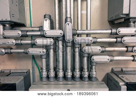 Electrical Conduit connected to junction box for connect electrical cable in box with vintage tone for industrial technology concept.