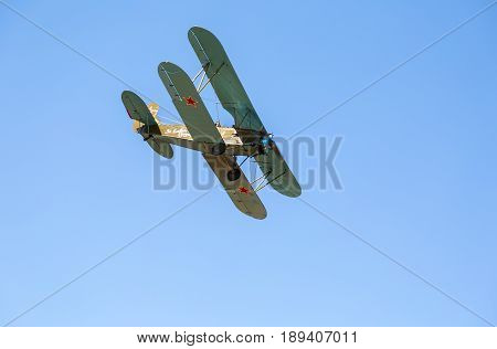 Samara Russia - April 30 2017: Retro Russian aeroplane Polikarpov PO-2 in the blue sky. Text in russian: For friends of fight