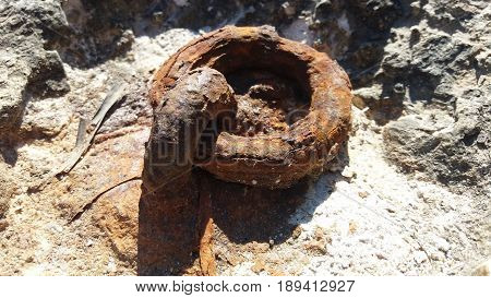 rusty old chain rings on the stone
