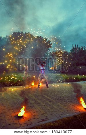 Fiery show on the street in the dark.