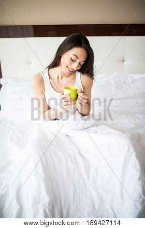 Beautiful Girl At Her Bedroom Drinking Tea In The Morning.