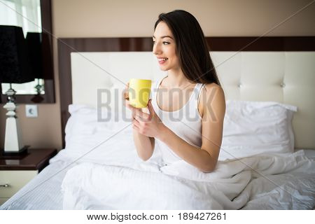 Beautiful Girl At Her Bedroom Drinking Tea In The Morning.