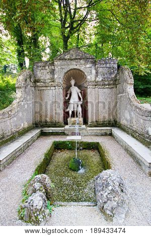 The trick fountain in Hellbrunn palace Salzburg Austria. Artemis's statue in the park of fountains.