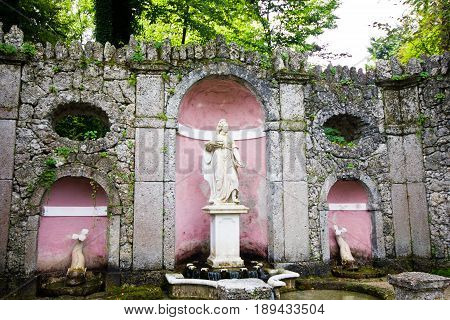 The trick fountain in Hellbrunn palace Salzburg Austria. Statue in the park of fountains.