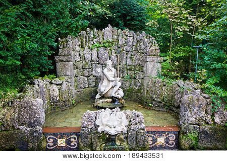 The trick fountain in Hellbrunn palace Salzburg Austria. Neptune statue in the park of fountains.
