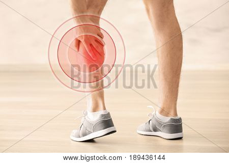 Health care concept. Man suffering from pain in calf, closeup
