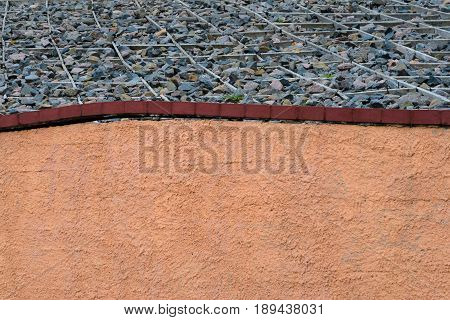 The foundation of the fence. Elements of multimaterial fence wood planks brick walls and stone base