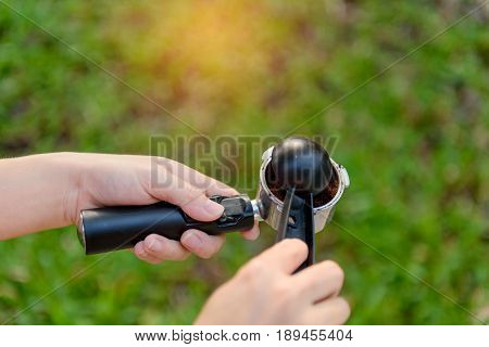 Tamping Fresh Ground Coffee.