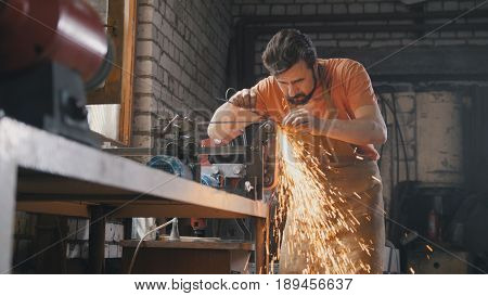 Sharpening iron tools with sparkles - forge workshop, slider shot