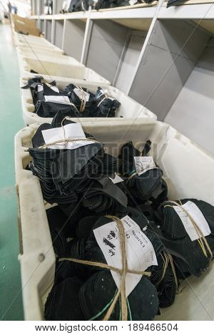 MOSCOW, RUSSIA - FEBRUARY 21, 2017: Moscow shoe factory JSC RALF RINGER. Cutting of leather parts in a plastic boxes. Shoe factory