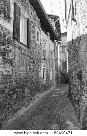 Asso (Como Lombardy Italy): typical street in the historic town. Black and white