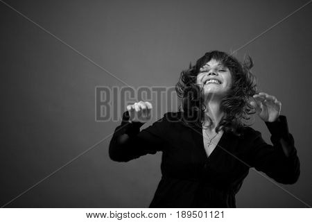 The girl introvert dances enjoying solitude music and freedom of voice. Her hair develops in time with her free movements