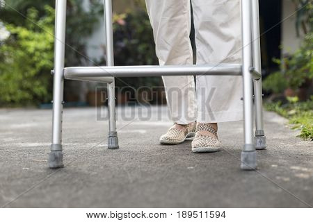 senior woman using a walker at home.