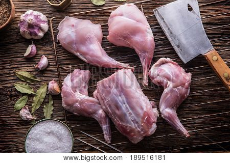 Rabbit. Raw rabbit slices with spices garlic kitchen utensilfork and butcher. Hunting cuisine.