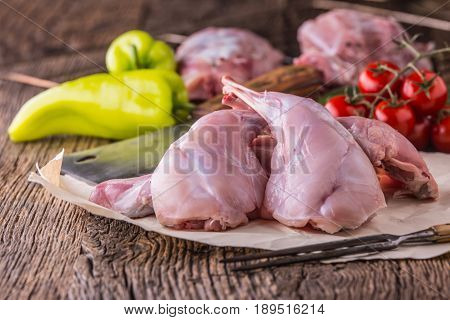 Rabbit. Raw rabbit slices with spices garlic kitchen utensilfork and butcher. Hunting cuisine.
