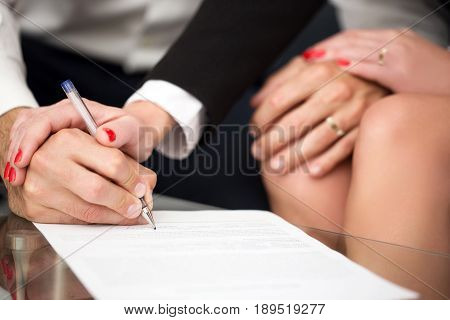 Man signing marriage settlement rich woman pulling into it