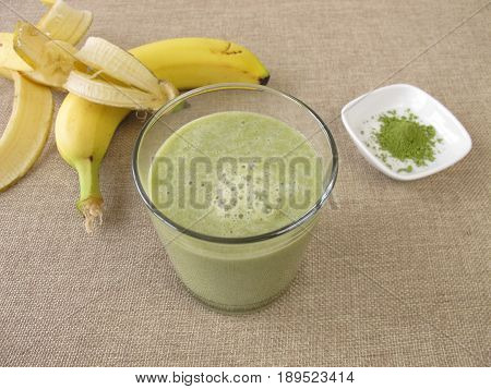 Drinking glass of matcha shake with banana