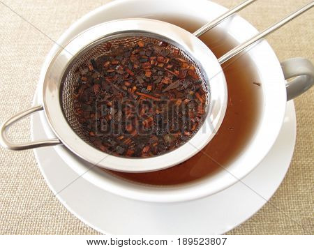 Loose honey bush tea in tea strainer