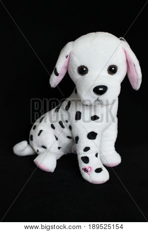 A Dalmatian dog toy with black spots for decoration