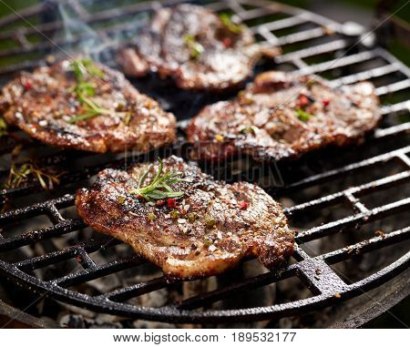 Grilled pork neck fillet steaks on grilled plate