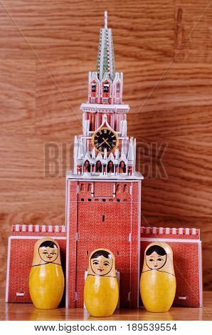 SARANSK, RUSSIA - June 03, 2017: Group of Matryoshka dolls near model of Spasskaya Tower.