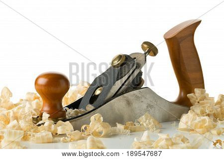 Woodworking hand planer tool on wooden boards in carpenter's workshop against white background with copy space
