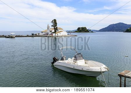 KANONI, GREECE - MAY 15: Tourists visit the old Greek Christian Orthodox church Vlacherna Monastery on May 15, 2017 in Kanoni, Corfu island in Greece.