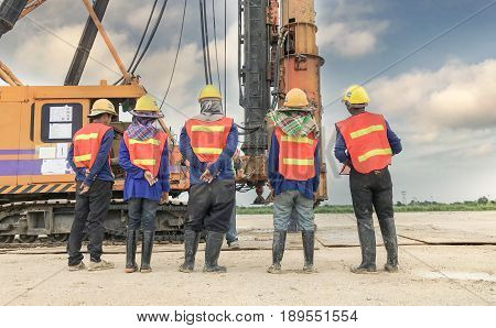 Construction team work in standard construction safety uniform installing precast concrete railway in mega project construction site