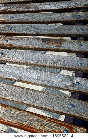 Texture of wooden gray bars of a park bench