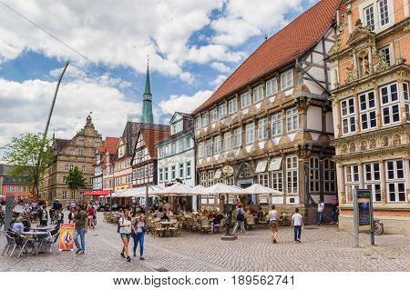 HAMELN, GERMANY - MAY 22, 2017: Cobblestoned street with historic houses, cafes and restaurants in Hameln, Germany